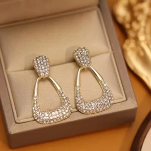 Elegant geometric diamond earrings with 18K gold plating, displayed on a neutral background